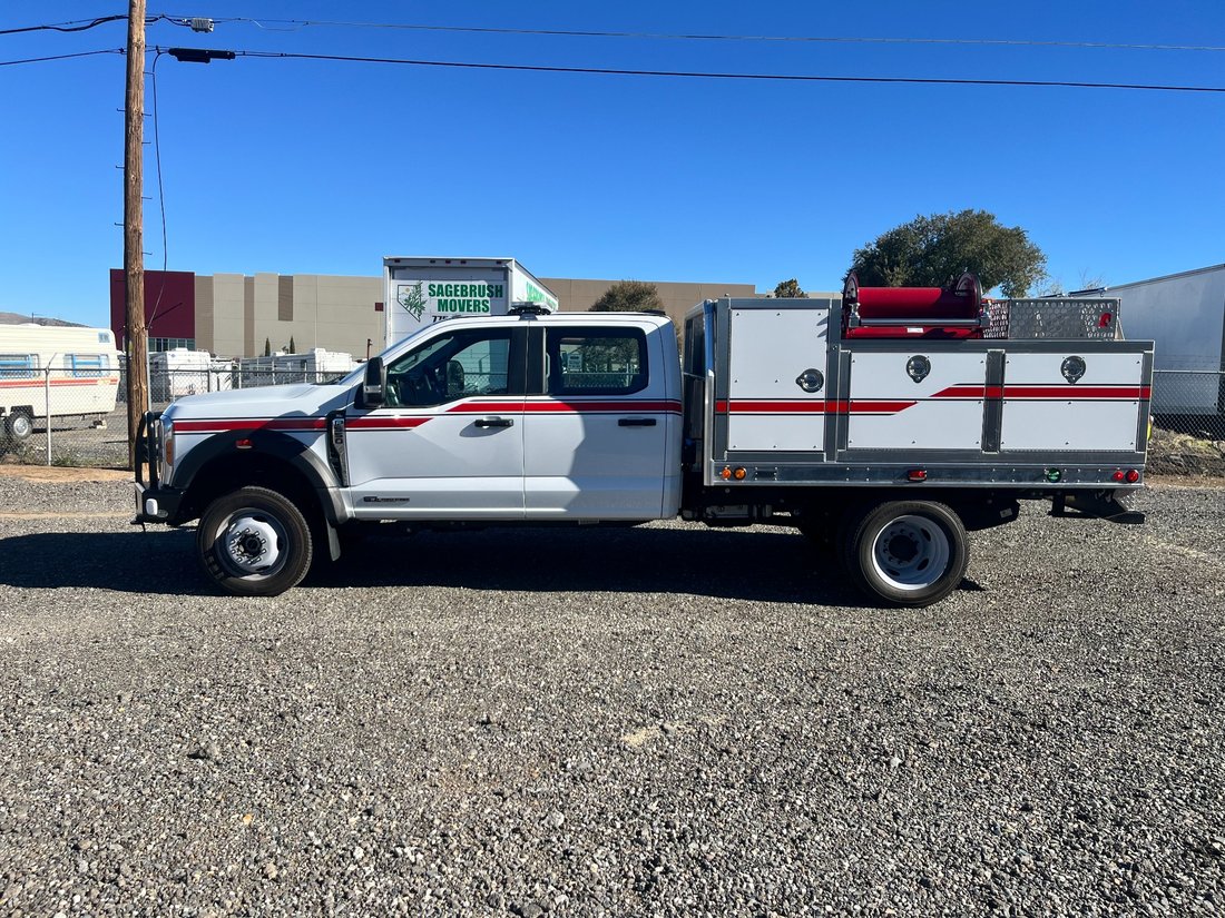 Wildland fire truck on gravel lot, side angle